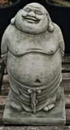 Beautiful statue of the smiling Chinese Buddha, on the stand