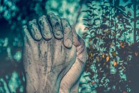 praying hands of a statue