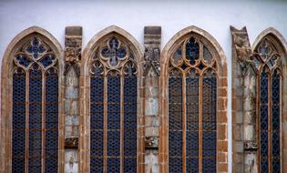 antique glass windows on a church facade