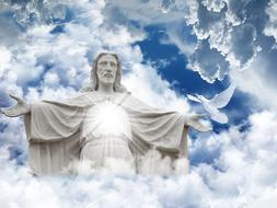Jesus sculpture and a white dove on a background cloudy sky