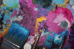 brushes, palette and mixed oil paints