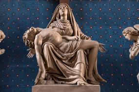 Beautiful marble sculpture of Christ, at blue, red and white wall on background
