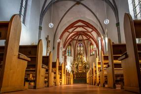 Beautiful and colorful interior of the church with benches and lights
