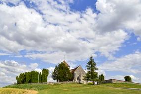 Beautiful landscape of the church on the colorful fields in La Genevraye, France