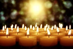 lot of burning Candles at bokeh background