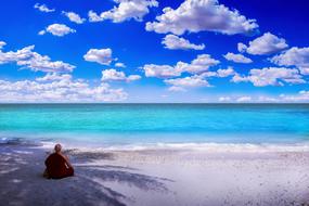 Buddhist is meditating on the beach in Malaysia