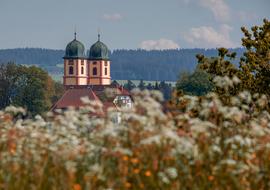 two Steeples of Baroque Church at rural summer landscape