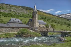 landscape of stone Church near River Water on hill