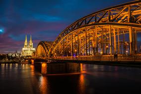 cityscape of illuminated castle bridge over Rhine in Cologne at Night