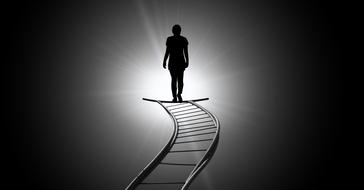 human silhouette walking away from darkness to light