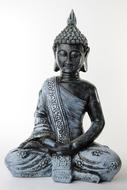 silver buddha figurine on white background