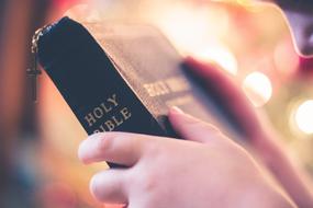 bible in leather cover in hand