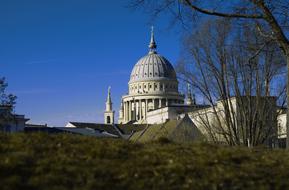 Beautiful landscape with the church, among the plants, and at blue and violet sky on background, in autumn