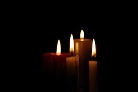 flame of four candles in the dark
