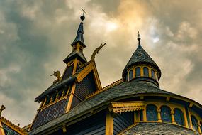 Beautiful and colorful, old church in Norway, at beautiful and colorful sunset, among the clouds