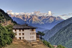 white building on the background of Meili Snow Mountains in China