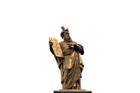 golden statue of Moses with 10 commandments on a white background