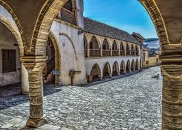 Beautiful, old monastery, with the arcade, in Omodos, Cyprus, Greece, under the blue sky