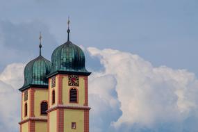 two Steeples of Baroque Church at cloudy sky