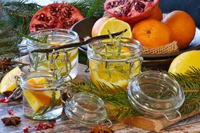 Beautiful and colorful Christmas still life wit the fruits, green fir branches and containers