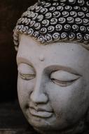 white stone buddha head