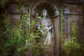 stone statue of a woman on the facade of the tomb