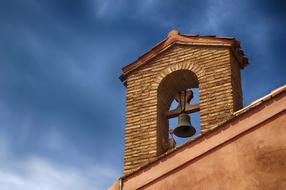 stone bell tower on the roof on a sunny day