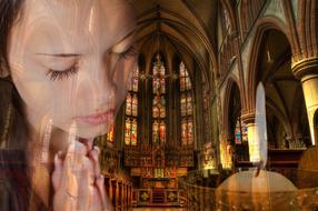 photo of a praying girl on the background of the interior of the Catholic Cathedral