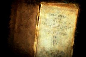 Old Christian Bible Book on black background