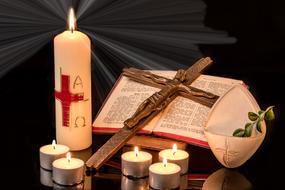 Easter still life, Candles and Cross on open bible