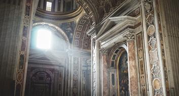 lighting of the interior of the Basilica of St. Peter through the window