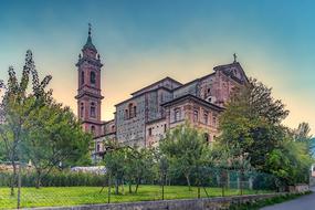 old red brick Church building in garden, Italy, Garessio
