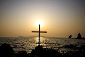 cross on Sea Beach at Sunset