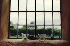 photo of candlesticks on a stone window sill