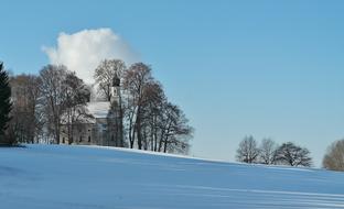 distant view of the church among the trees in a winter landscape