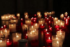 Beautiful and colorful, burning candles, among the darkness