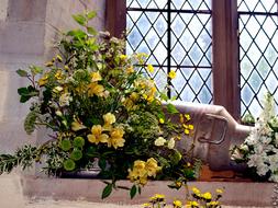 yellow and white flowers on a church window