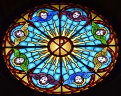 round colorful stained glass window on dark close-up