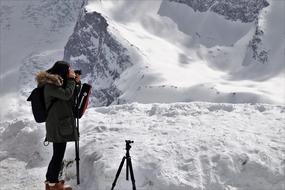 Girl taking Photography on Snowy mountain, poland