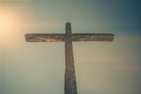 aged stone cross at sky, brazil
