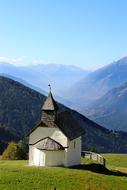 old small Chapel on Mountain side at scenic landscape