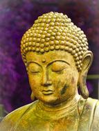 head of a golden buddha on a purple background