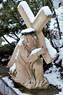 sculpture of Jesus Christ with cross