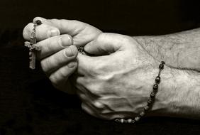 rosary in hand for prayer