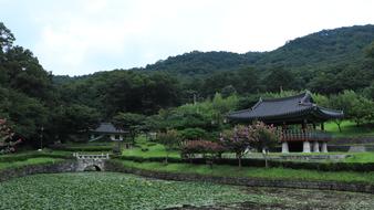 picturesque pond and Korean temples near the green mountains