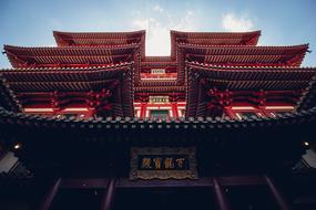 red carved roofs of traditional Asian Building at sky