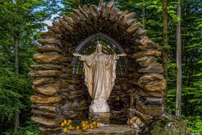 Jesus in cave, sculpture at forest