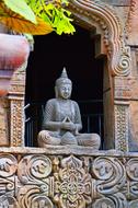Buddha Statue in ornate carved niche
