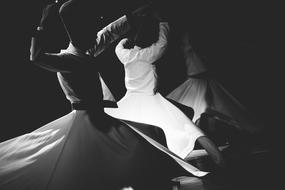 Black and white photo of the dancing people in Turkey