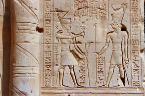 engraving pharaoh and hieroglyphs on the wall